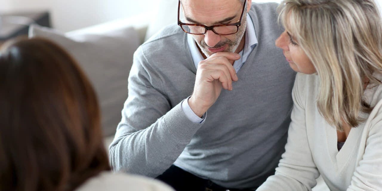 A man and woman sitting next to each other. A man and woman sitting next to each other.
