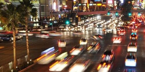 A busy city street with lots of traffic lights.