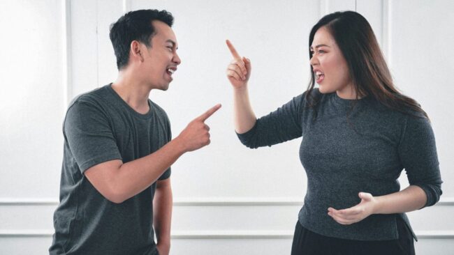 Two people arguing, pointing fingers intensely. Two people arguing, pointing fingers intensely.