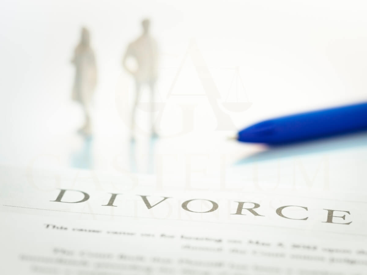 Blurry silhouette of a couple and the word 'Divorce' with a blue pen, symbolizing amicable divorce and peaceful separation.
